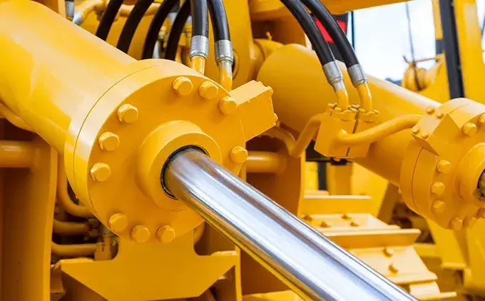 Close-up of bright yellow hydraulic cylinders and hoses, crucial for hydraulic systems. Ideal for hydraulic shop near me, hydraulic repair service, hydraulic equipment supply, hydraulic fittings,hydraulic equipment supplier,hydraulic company in dubai