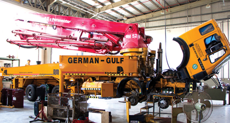 Full view of a Putzmeister concrete pump truck undergoing repair at a German-Gulf workshop, highlighting our expertise in servicing concrete and mortar machinery.